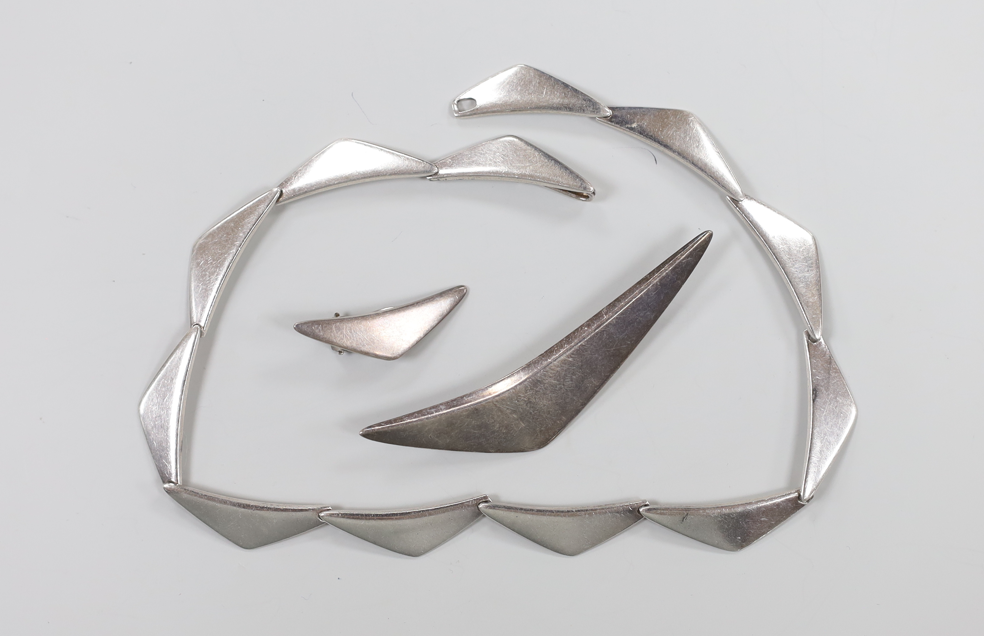 A 20th century Danish sterling necklace, by Hans Hansen design no. 315, 35.5cm, together with a similar brooch, design no. 113 and single ear clip, design no. 432.